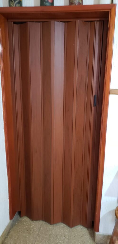 Puerta plegadiza de PVC símil madera ciega